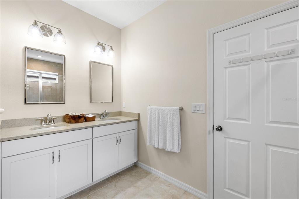 16716 Wingspread Loop Winter Garden, FL 34787 - Photo 20 of 56 a bathroom with double vanity sink and a mirror