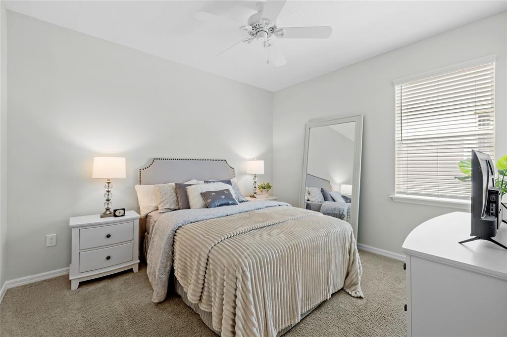 16716 Wingspread Loop Winter Garden, FL 34787 - Photo 23 of 56 a bedroom with a bed and a chandelier