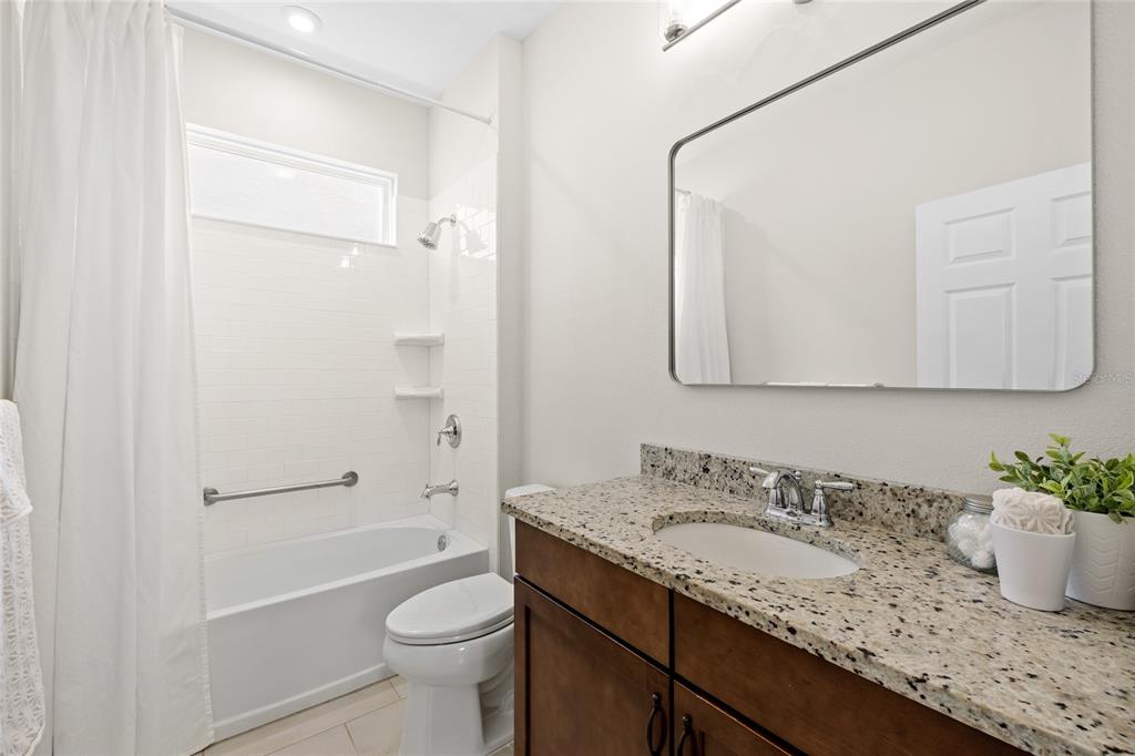 16716 Wingspread Loop Winter Garden, FL 34787 - Photo 25 of 56 a bathroom with a granite countertop sink toilet and shower