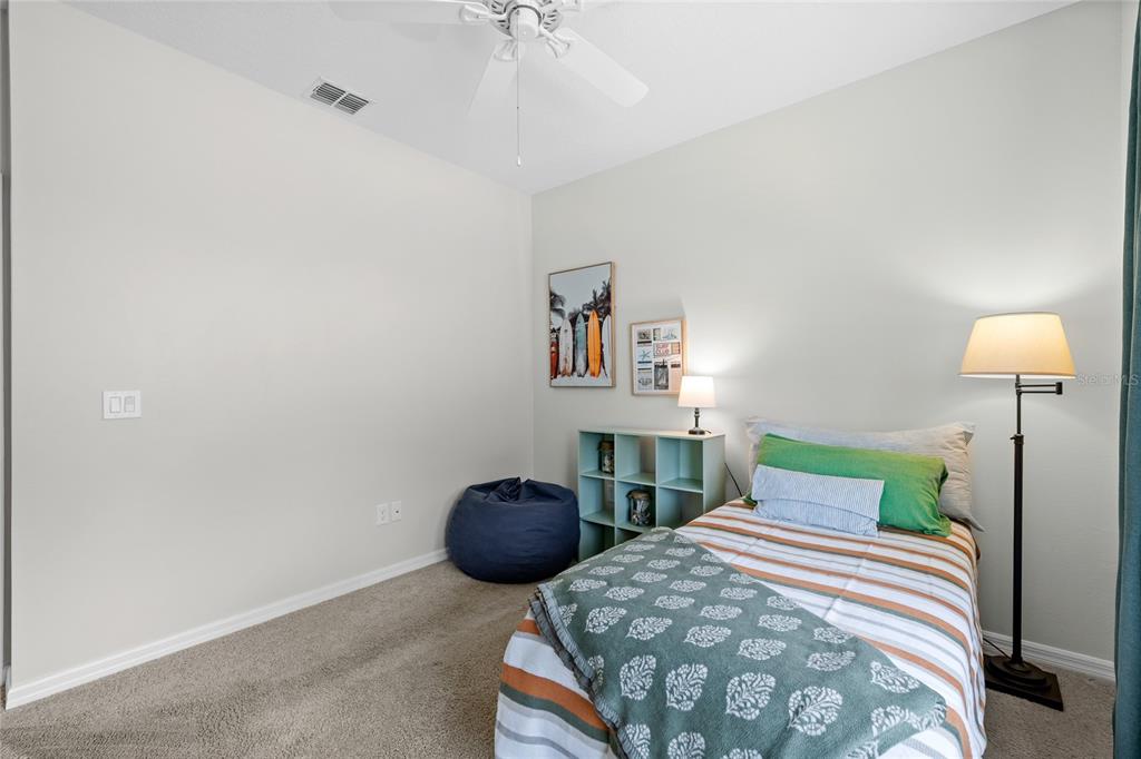 16716 Wingspread Loop Winter Garden, FL 34787 - Photo 27 of 56 a bedroom with a bed and a lamp