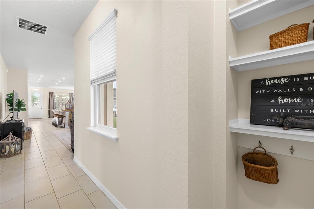 16716 Wingspread Loop Winter Garden, FL 34787 - Photo 31 of 56 a hallway with a couch and a window