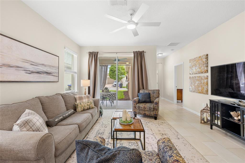 16716 Wingspread Loop Winter Garden, FL 34787 - Photo 5 of 56 a living room with furniture flat screen tv and a large window