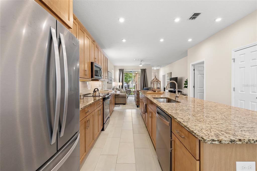 16716 Wingspread Loop Winter Garden, FL 34787 - Photo 7 of 56 a large kitchen with stainless steel appliances lots of counter top space