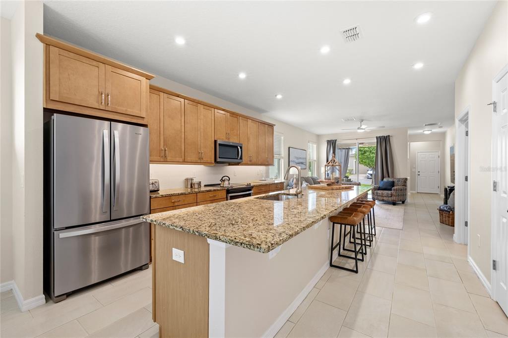 16716 Wingspread Loop Winter Garden, FL 34787 - Photo 8 of 56 a kitchen with stainless steel appliances granite countertop a refrigerator and a sink