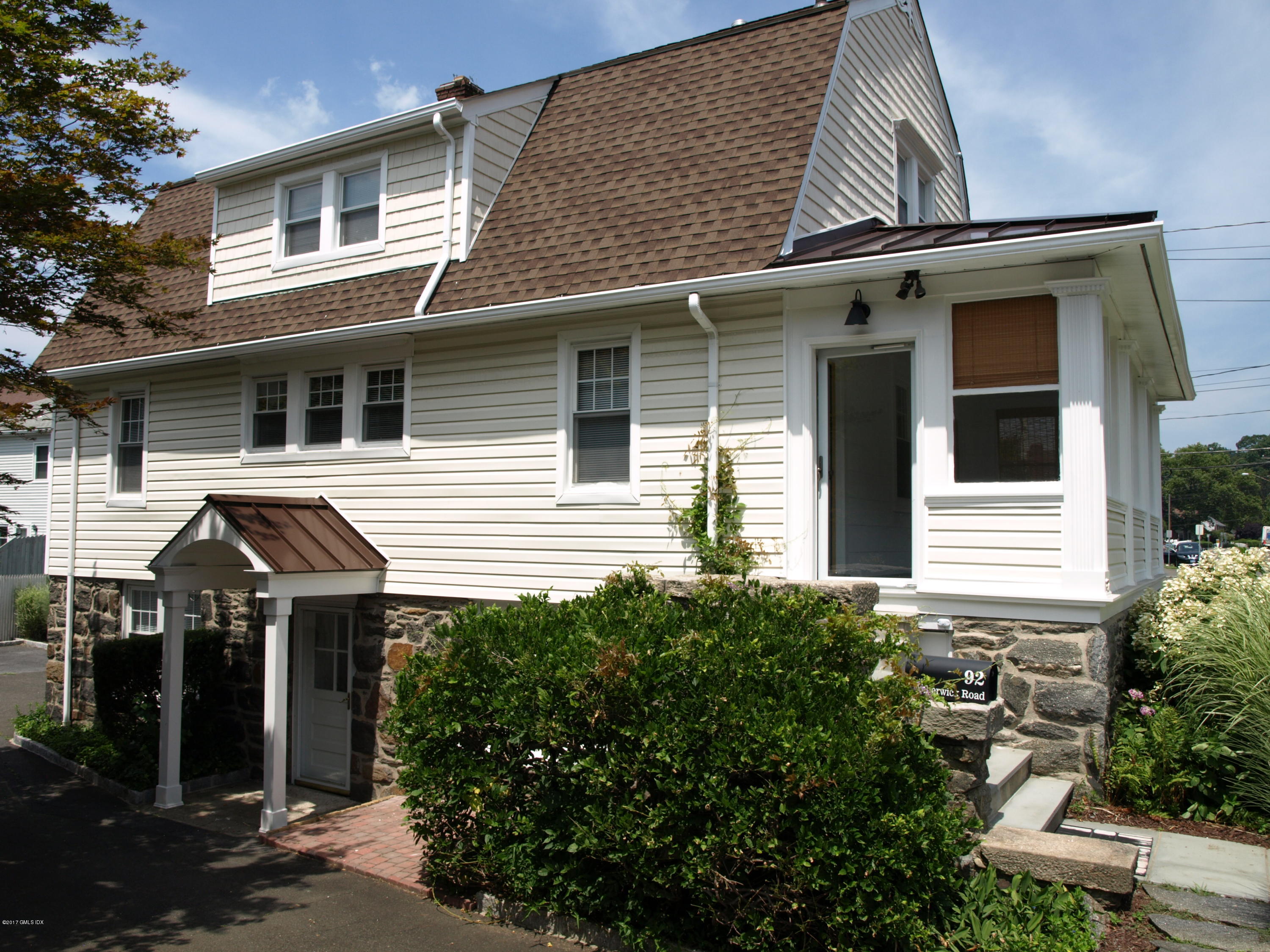 92 Pemberwick Road Greenwich, CT 06831 - Photo 2 of 2 a front view of a house with a yard