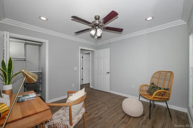 a view of a workspace with furniture and wooden floor
