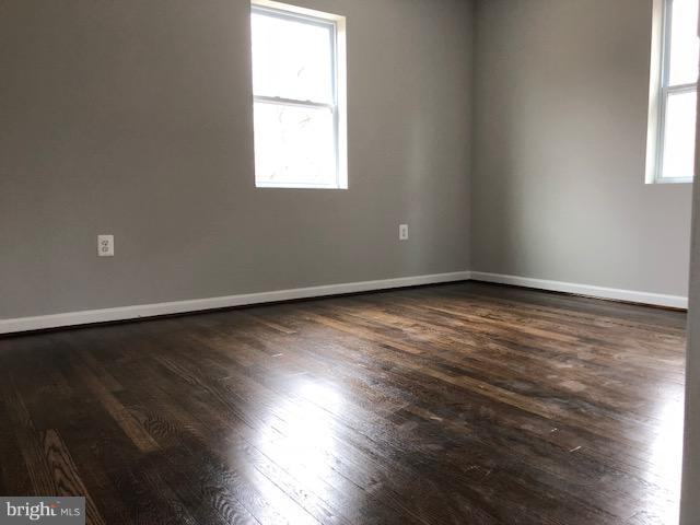 5 Patapsco Road Linthicum, MD 21090 - Photo 11 of 20 an empty room with wooden floor and windows