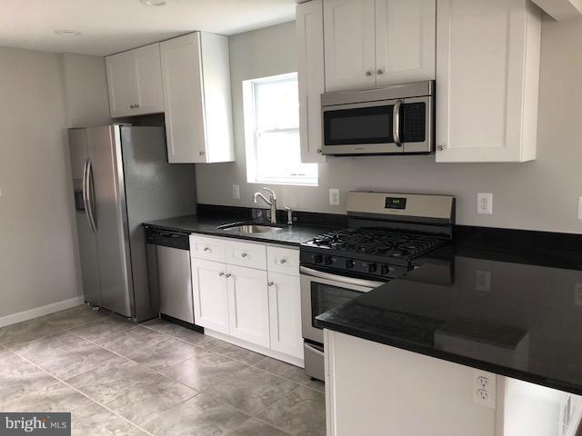 5 Patapsco Road Linthicum, MD 21090 - Photo 4 of 20 a kitchen with stainless steel appliances granite countertop a stove a refrigerator and a microwave