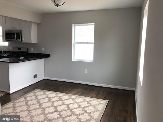 5 Patapsco Road Linthicum, MD 21090 - Photo 5 of 20 a view of a kitchen with a sink a microwave and cabinets