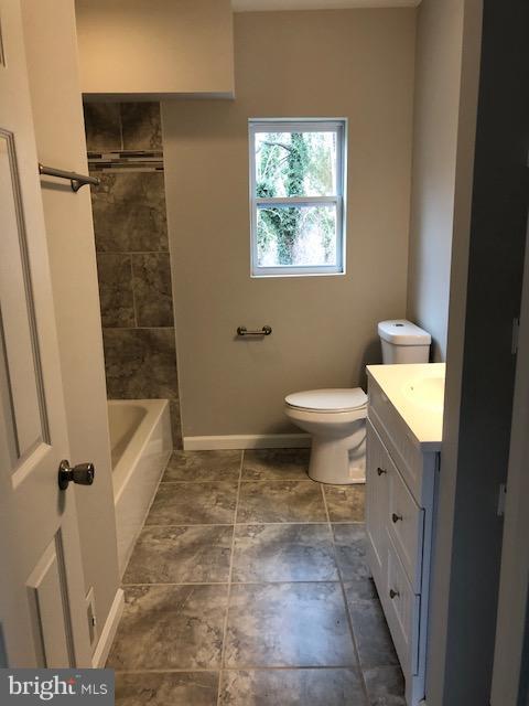 5 Patapsco Road Linthicum, MD 21090 - Photo 9 of 20 a bathroom with a sink a toilet and shower