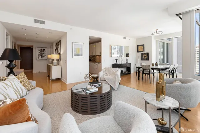 a large kitchen with stainless steel appliances granite countertop a lot of counter space and wooden floors