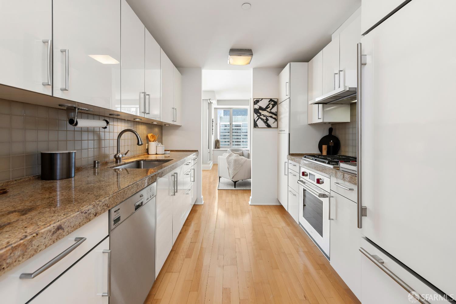 188 Minna, Unit 24A San Francisco, CA 94105 - Photo 13 of 43 a large kitchen with stainless steel appliances granite countertop a lot of counter space and wooden floors