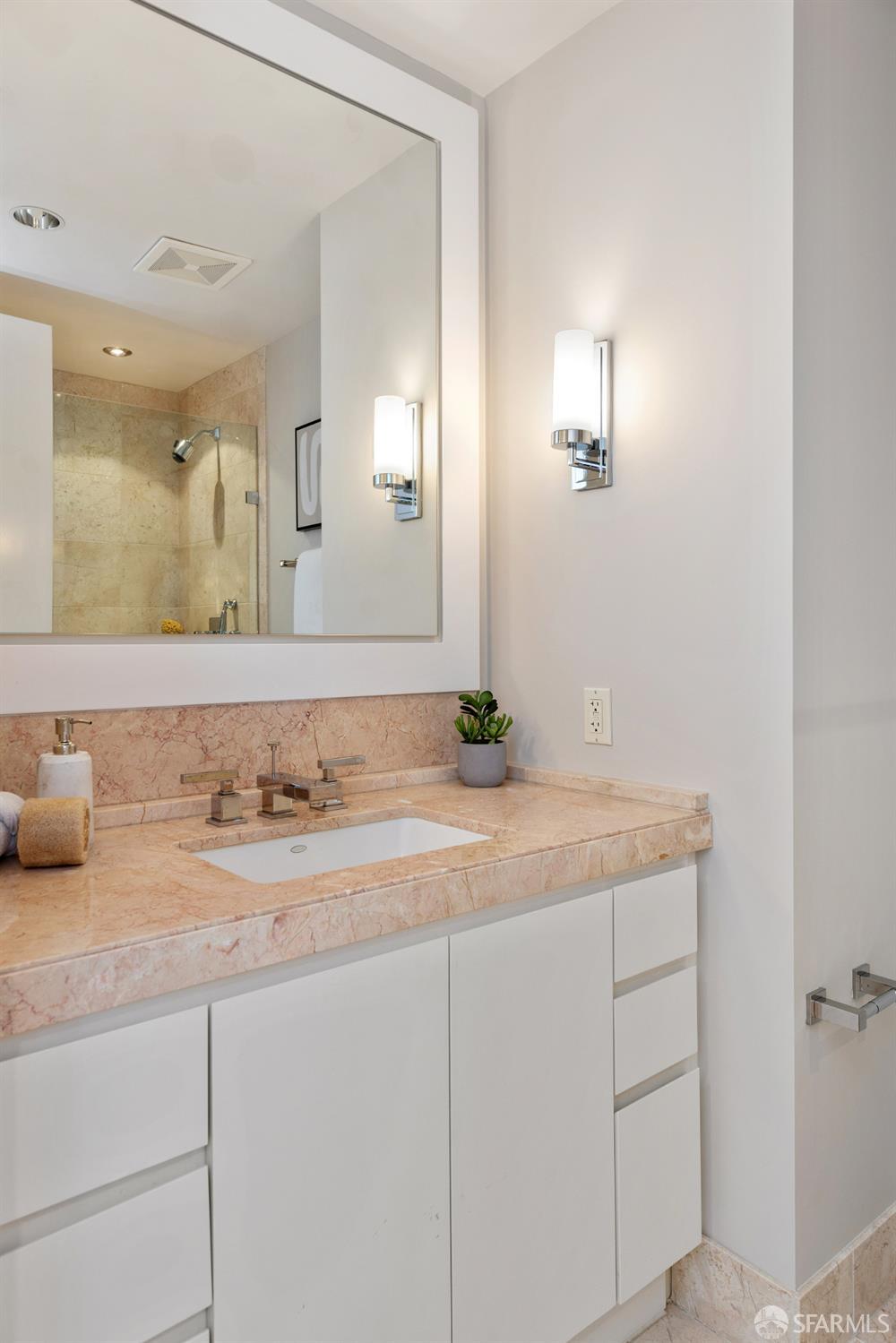 188 Minna, Unit 24A San Francisco, CA 94105 - Photo 23 of 43 a bathroom with a granite countertop sink and a mirror