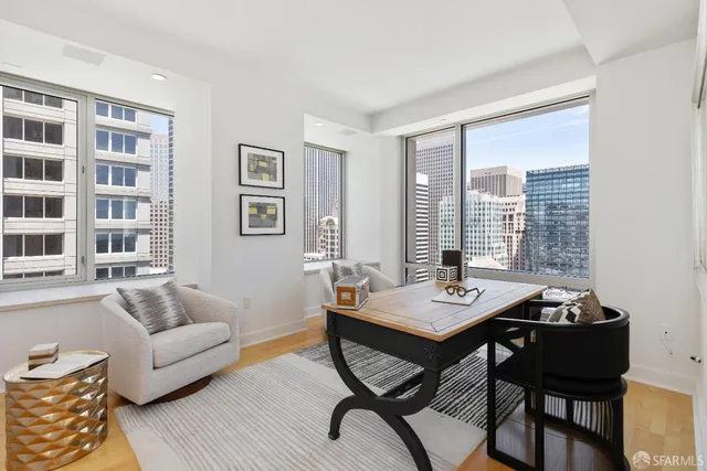 a living room with furniture and a floor to ceiling window