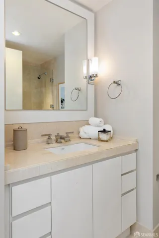 a bedroom with furniture and a lamp