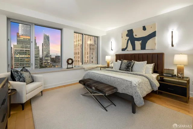 a spacious bedroom with a bed and large windows