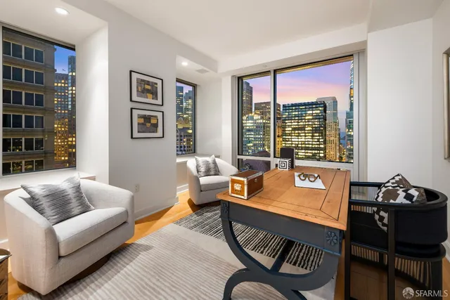 a living room with furniture and large window