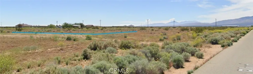 22300 Rickenbacker Court Edwards, CA 93523 - Photo 2 of 16 a view of a lake with houses in the background