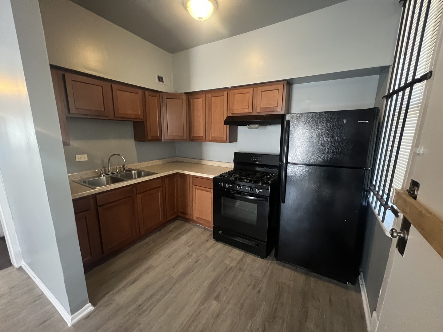 734 East 95th Street, Unit 1E Chicago, IL 60619 - Photo 6 of 7 a kitchen with a refrigerator stove and cabinets