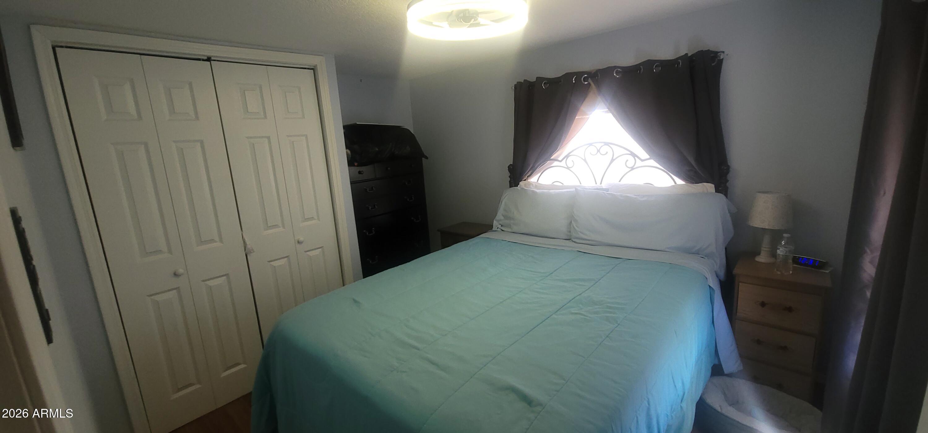 800 West Apache Trail, Unit 24 Apache Junction, AZ 85120 - Photo 7 of 11 a bedroom with window and bed