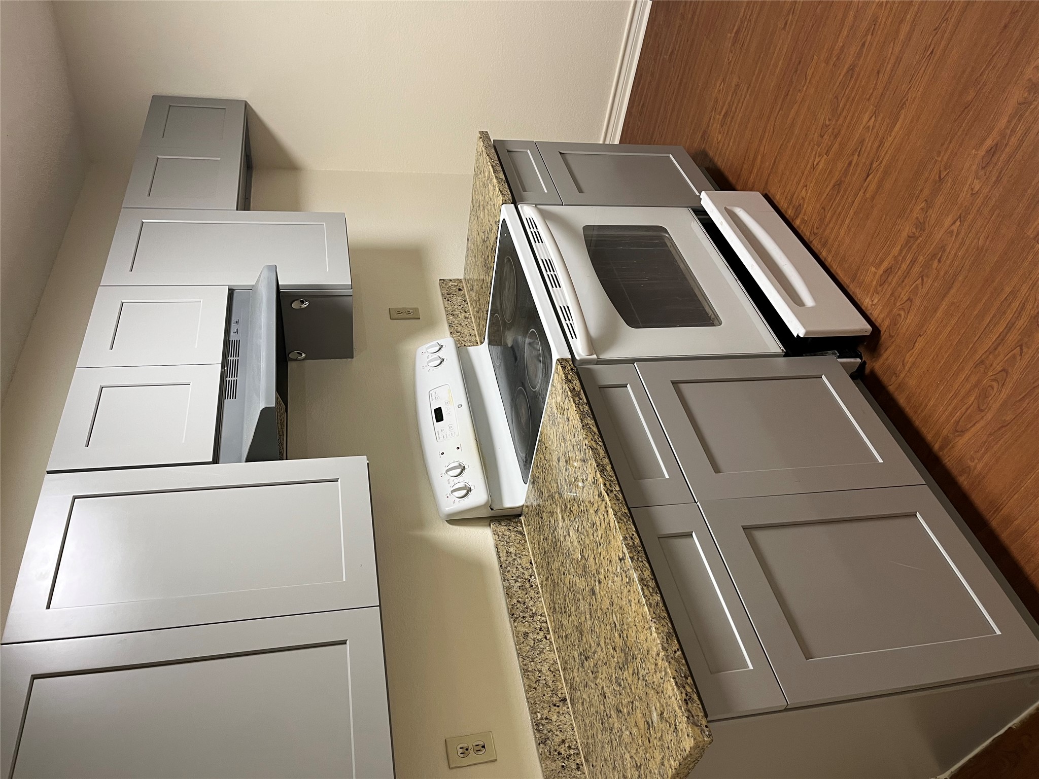 23393 Nameless Road, Unit 144 Leander, TX 78641 - Photo 5 of 23 Kitchen featuring extractor fan, gray cabinets, white electric range, and dark wood finished floors