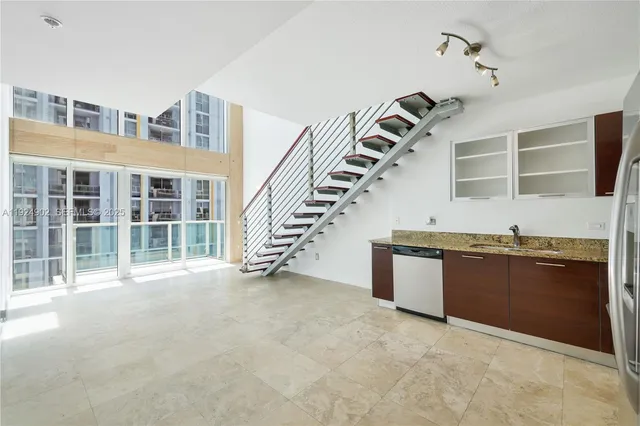 a kitchen with a refrigerator and a sink