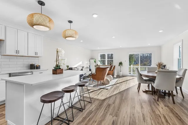 a view of a dining room with furniture wooden floor and chandelier