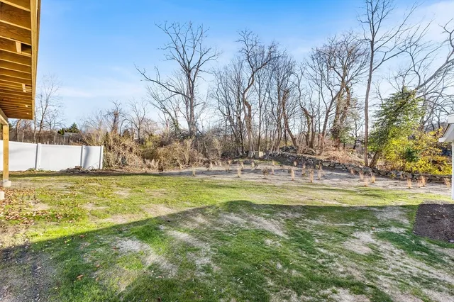 a front view of a house with a yard and balcony