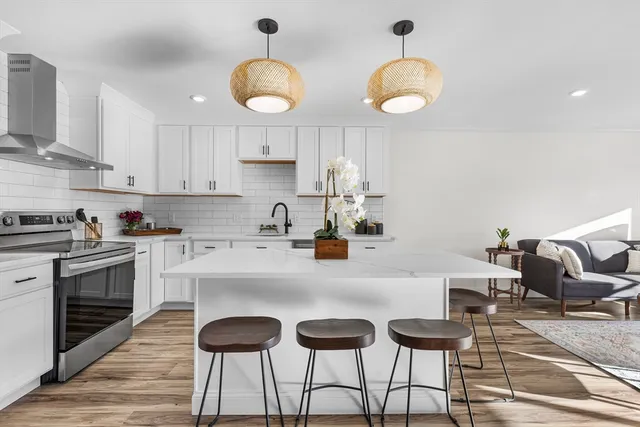 a kitchen with cabinets a center island and appliances