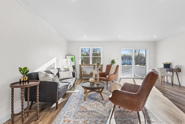 a living room with furniture kitchen and a table