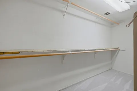 a bedroom with a bed and a potted plant