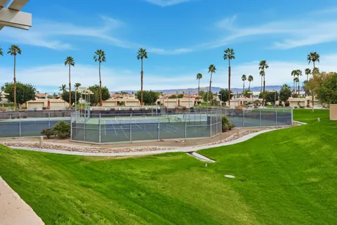a front view of a house with a garden and yard