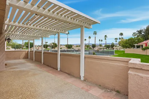 a view of a kitchen with a sink and dishwasher with wooden floor