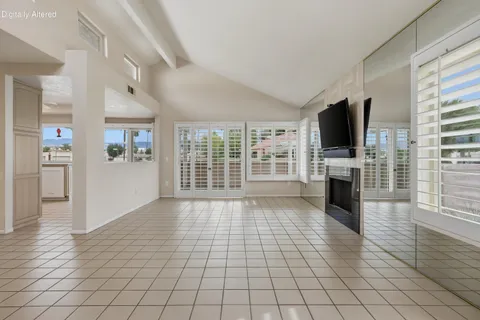 a view of an empty room with a fireplace and a window