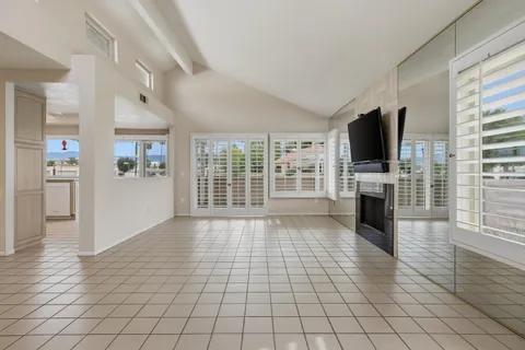a view of a livingroom with an empty space and a fireplace