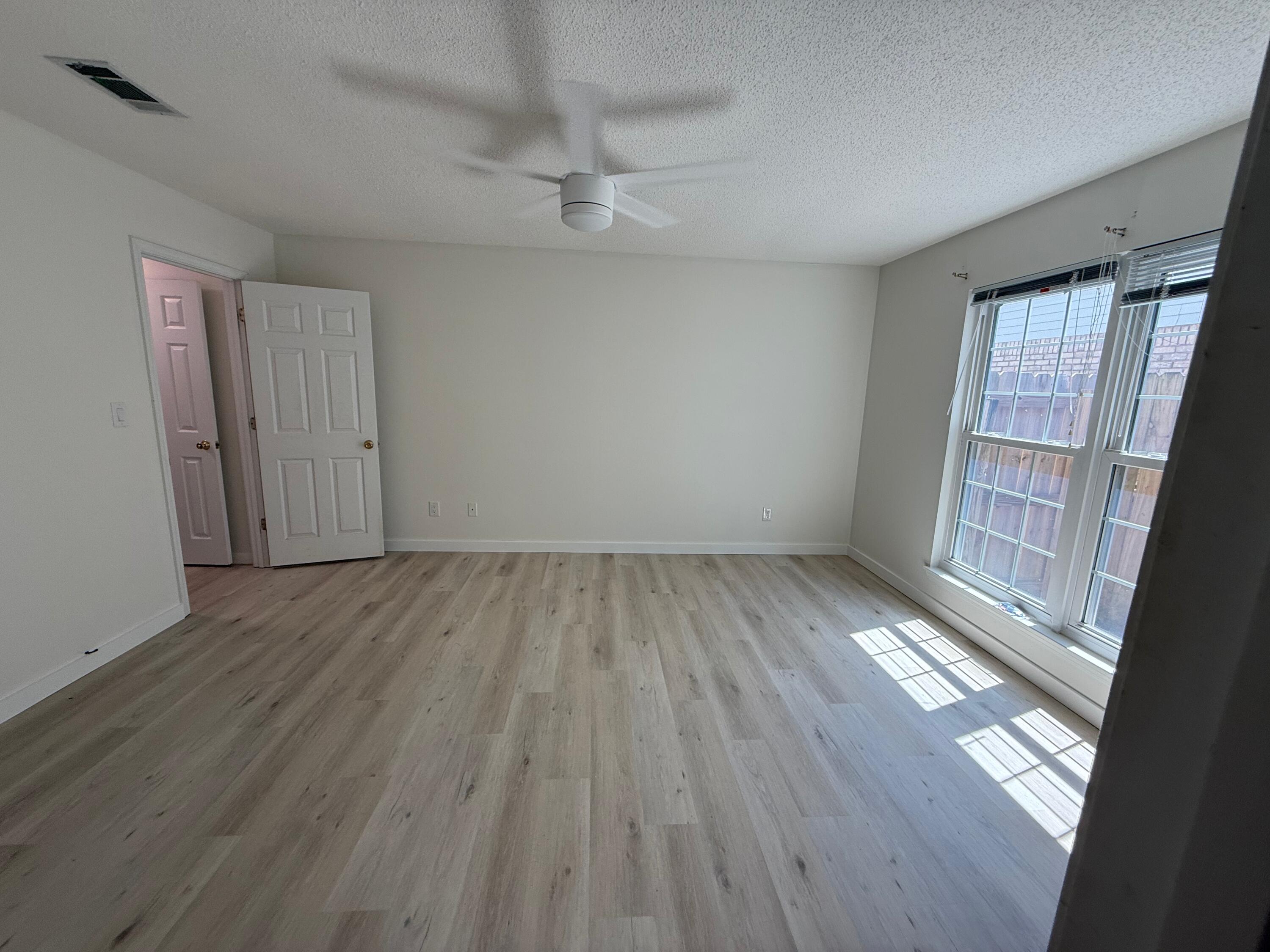 910 Elizabeth Lane Shalimar, FL 32579 - Photo 13 of 16 wooden floor in an empty room with a window