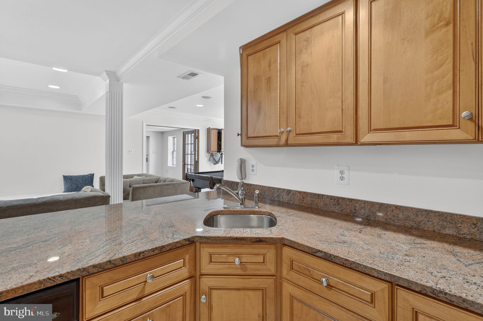 4531 Den Haag Road Warrenton, VA 20187 - Photo 66 of 103 a kitchen with granite countertop a sink a stove and cabinets
