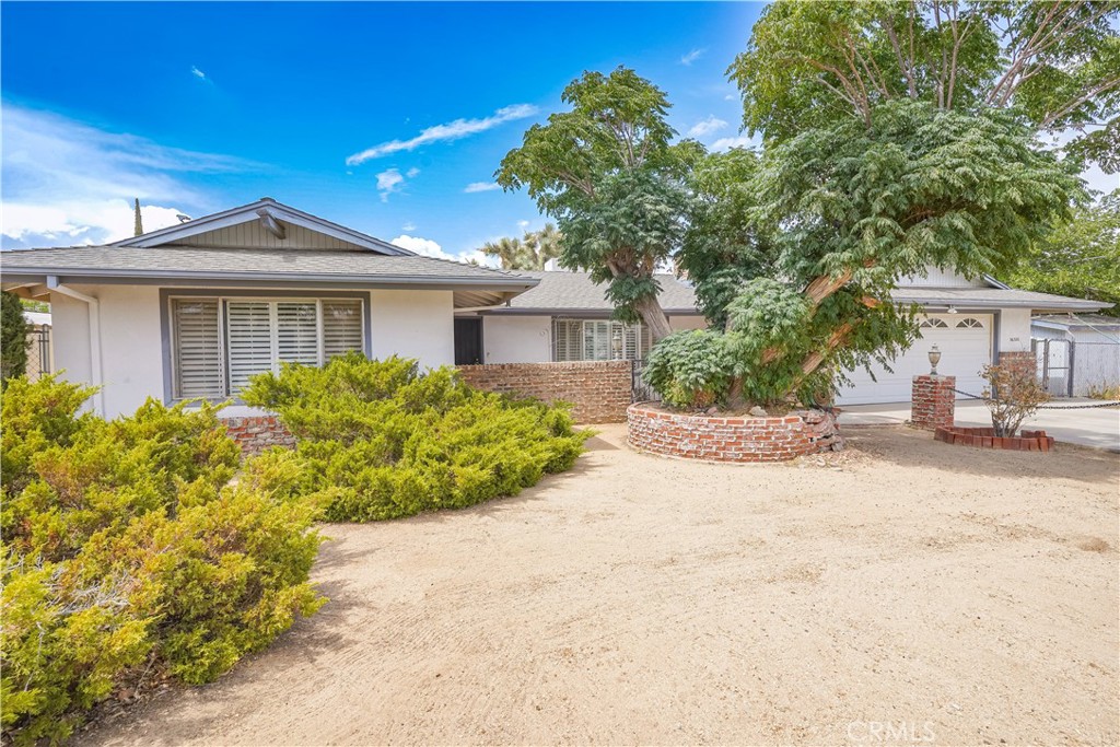 a front view of a house with a yard and a garage