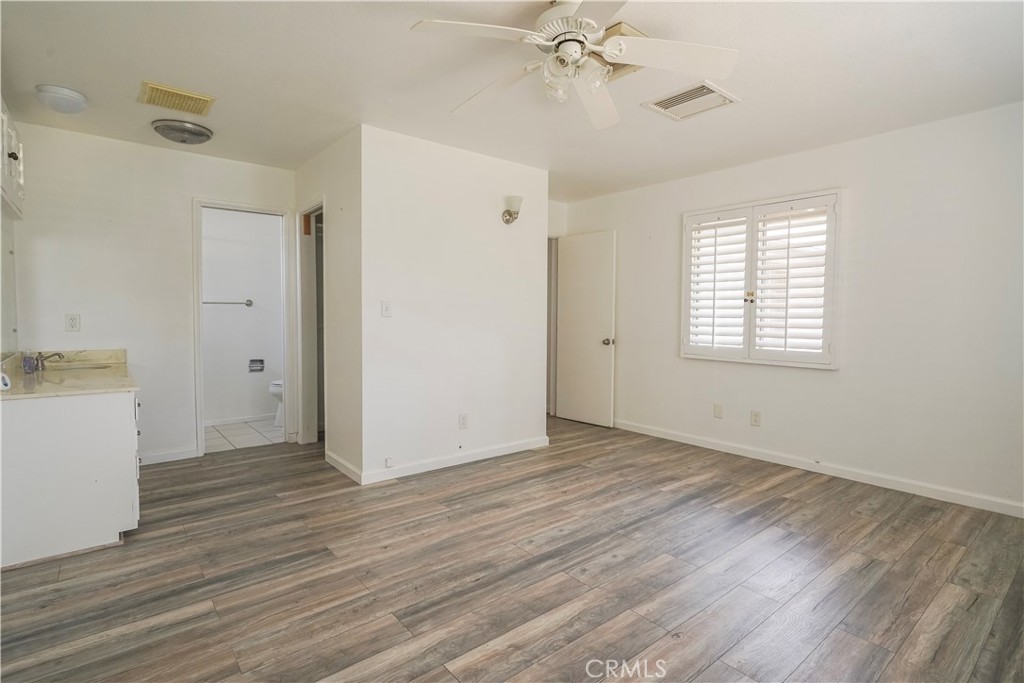 56320 Tamarisk Court Yucca Valley, CA 92284 - Photo 23 of 46 a view of an empty room with wooden floor and a window
