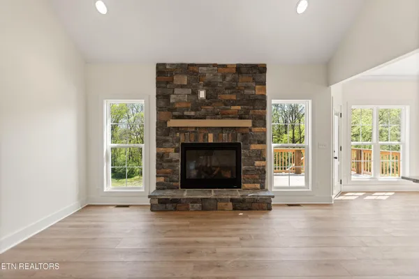 a living room with a fireplace and a floor to ceiling window