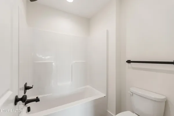 a bathroom with a bathtub and a toilet
