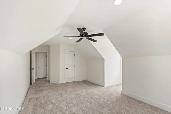 a view of a big room with closet and ceiling fan