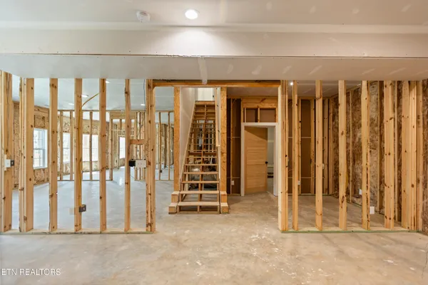 a view of a room with wooden floor and door
