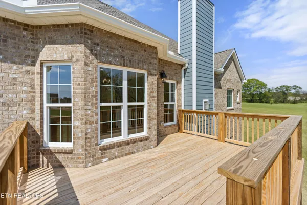 a balcony with wooden floor and fence