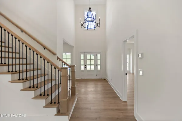 a view of entryway and hall with wooden floor