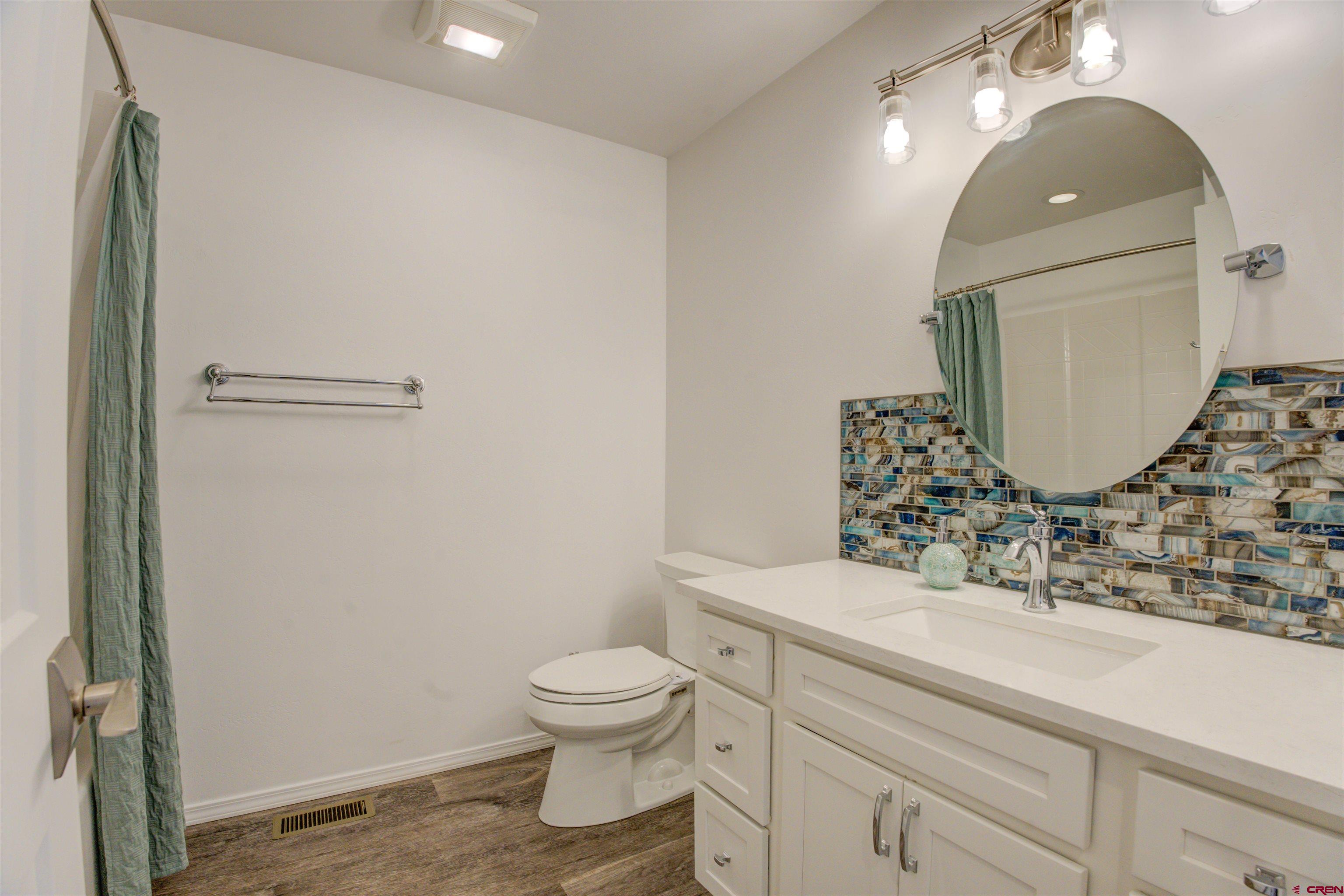 431 Juniper Place Cortez, CO 81321 - Photo 12 of 36 a bathroom with a toilet sink and mirror