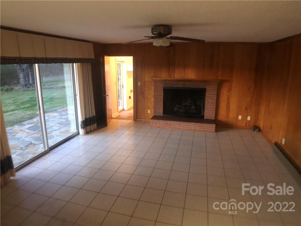 178 Skyview Ridge Rutherfordton, NC 28139 - Photo 28 of 43 a view of an empty room with a fireplace and a window