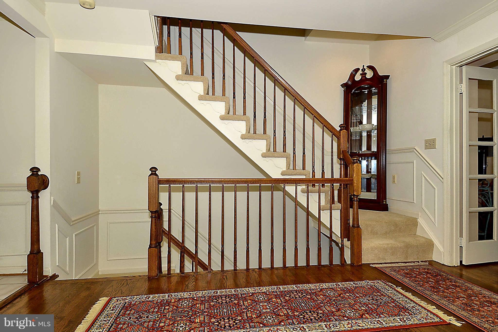 10708 Brewer House Road North Bethesda, MD 20852 - Photo 12 of 26 a view of staircase with white walls and a rug