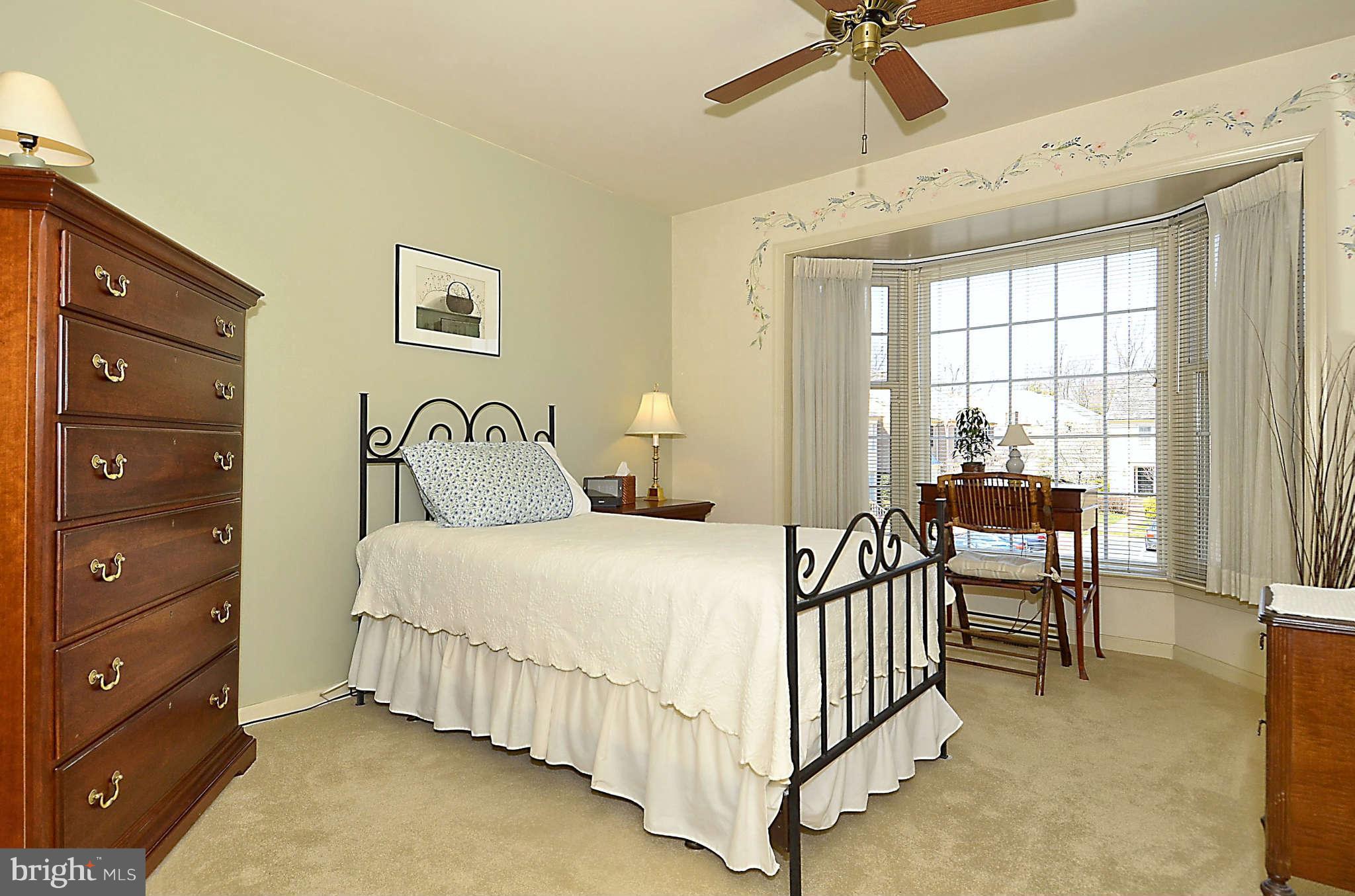 10708 Brewer House Road North Bethesda, MD 20852 - Photo 20 of 26 a bedroom with a bed and a chandelier
