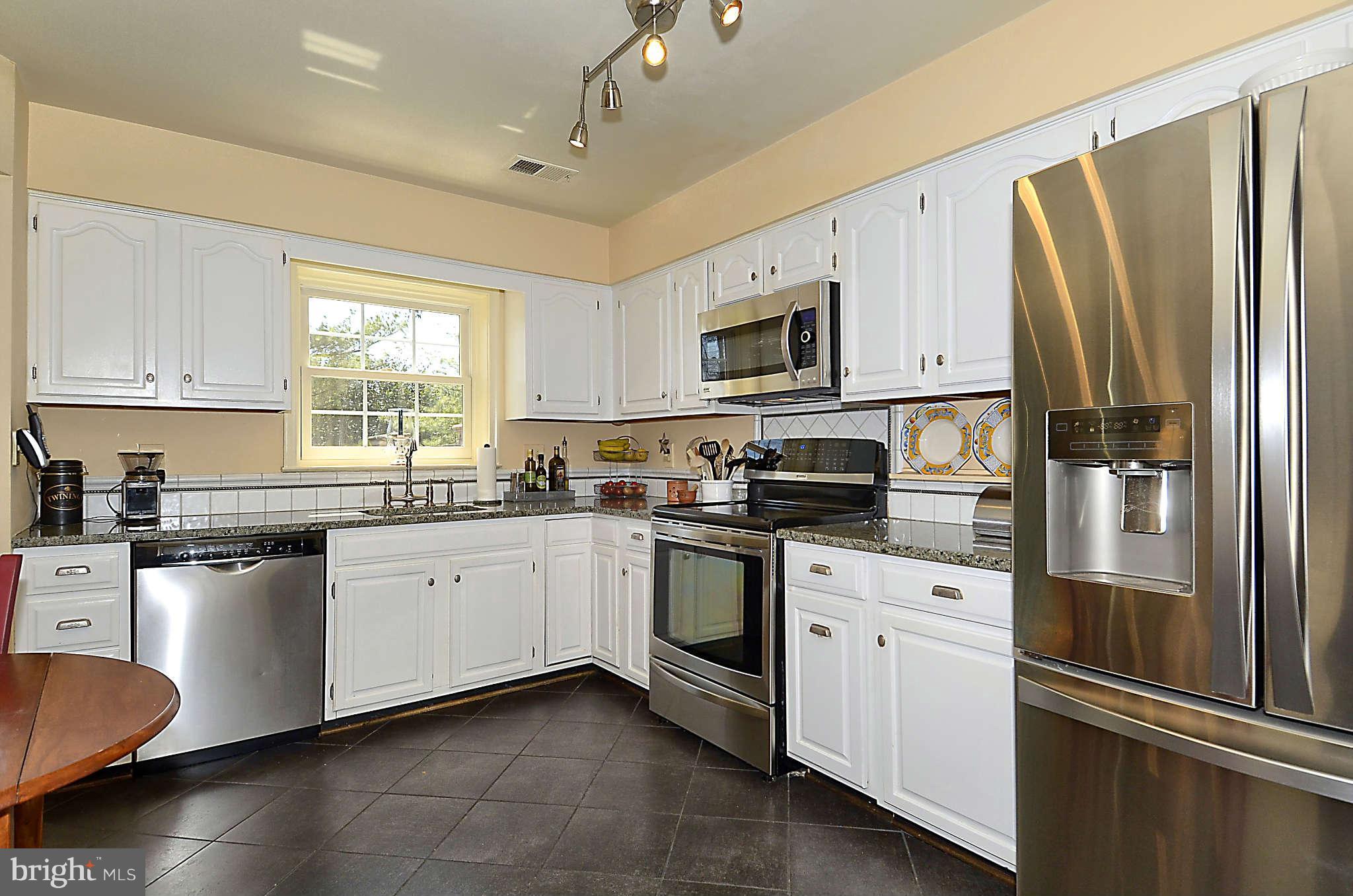 10708 Brewer House Road North Bethesda, MD 20852 - Photo 7 of 26 a kitchen with granite countertop a refrigerator stove top oven and sink